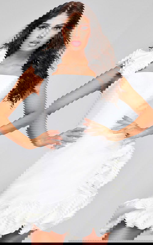 Model wearing Jovani 42348 white mini dress with square neckline and ruffled shoulder detail.