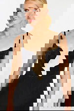 Close-up of wavy deep neckline with sheer insert on velvet jumpsuit