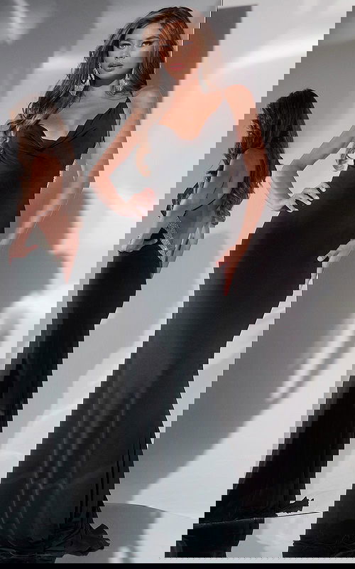 Model wearing Jovani 42438 elegant black dress with cowl neckline front view