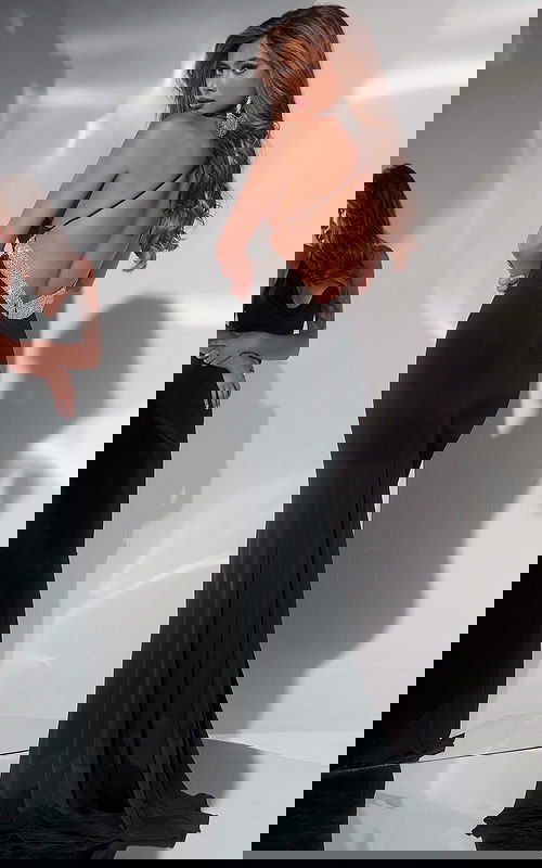 Model wearing Jovani 42438 elegant black dress with shimmering open back