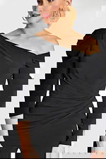 Close-up of asymmetrical neckline and ruched waist on black jumpsuit