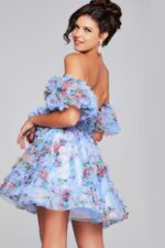 Model wearing Jovani 42573 blue dress, back view showing ruffles.
