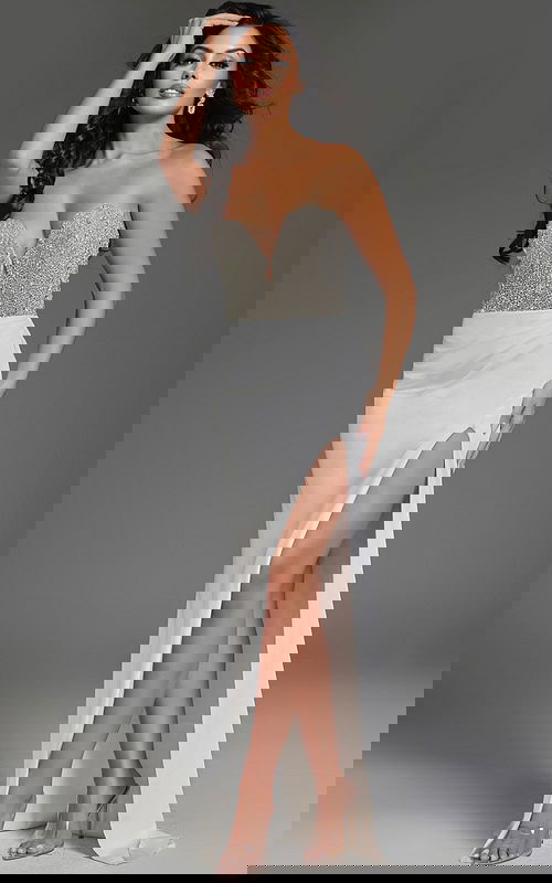 Model wearing Jovani 42637 elegant off-white gown with a sweetheart neckline and high slit.