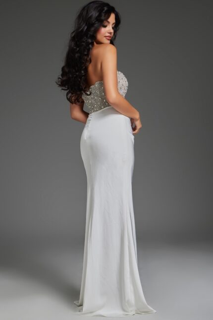 Back view of model wearing Jovani 42637 off-white gown with embellishments.
