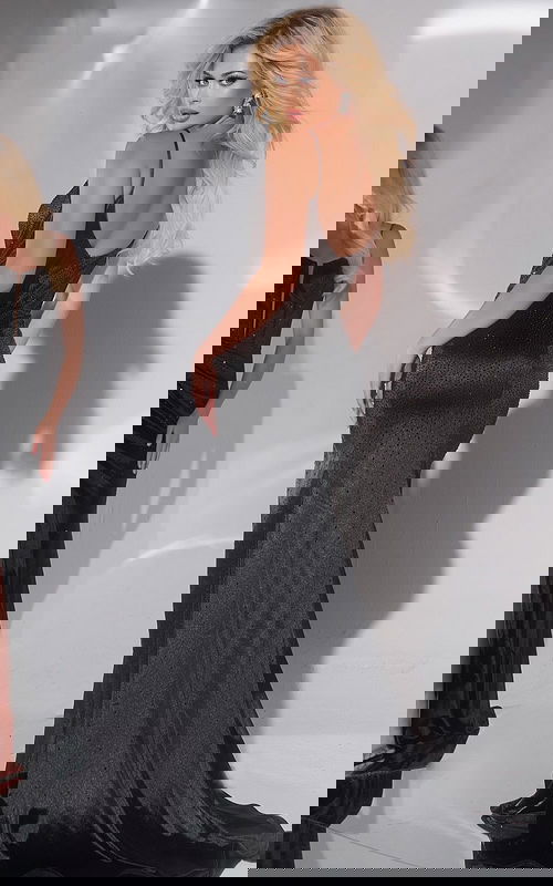 Back view of model wearing Jovani 42639 black gown with scoop back design.