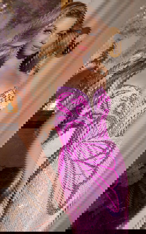 Model wearing Jovani 42690 pink gown with intricate beadwork and strapless design.