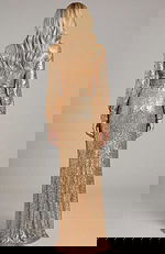 Back view of long sleeve sequin evening gown with straight silhouette and floor length design