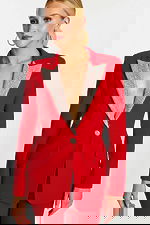 Close-up of red blazer with embellished lapel and button detail