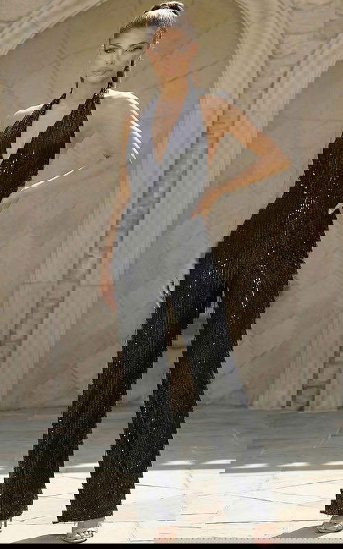 Halter neck sequin jumpsuit with deep V neckline and fitted waist