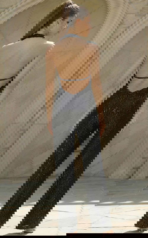 Back view of open back sequin jumpsuit with straight leg design