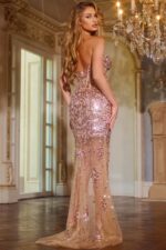 Model wearing Jovani 42779 nude gown back view showcasing intricate embellishments.