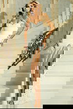 Model wearing strapless satin gown with embellished slit and sweetheart neckline