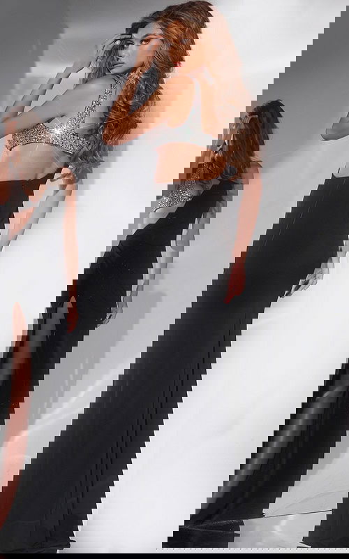 Model showing the back of Jovani 42816 black gown with asymmetric design