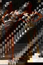 Metallic gold and bronze gowns with high slits and draped detailing