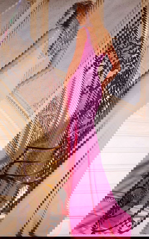 Back view of model wearing Jovani 42899 pink gown with fitted silhouette.