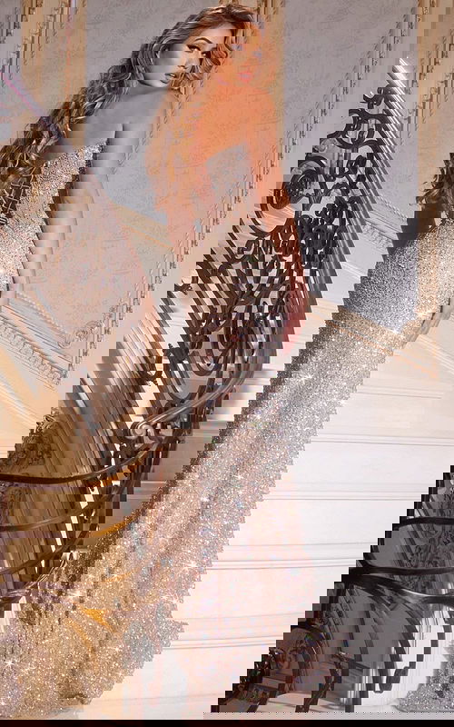 Model wearing Jovani 42920 nude gown with corset back, back view.