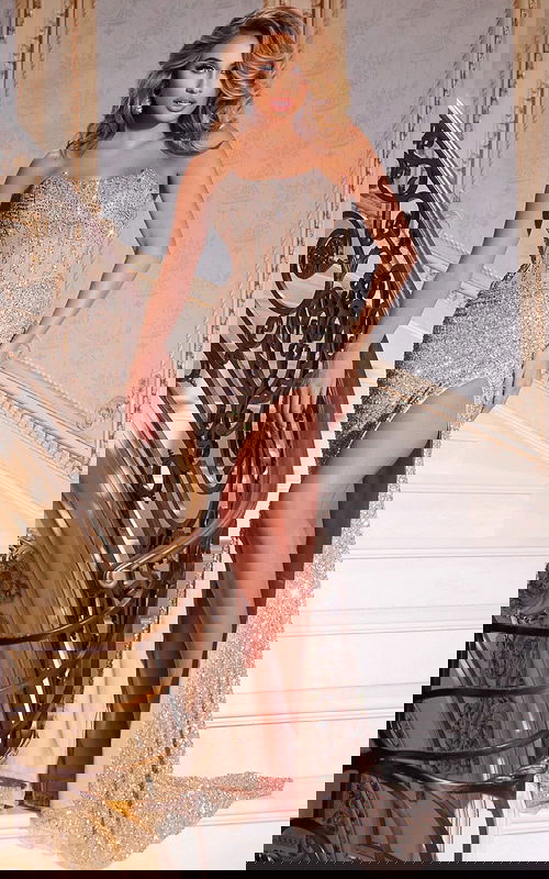 Model wearing Jovani 42920 nude gown, front view with high slit.