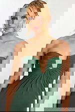 Close-up of ruched plunging neckline on green sheath dress