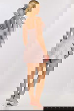 Close-up of rosette details on soft pink tweed party dress