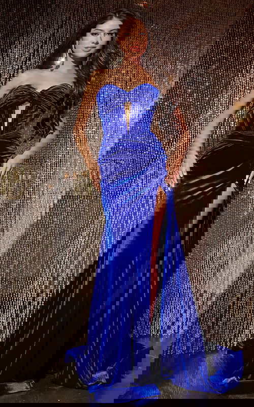 Model wearing Jovani 43066, a Royal Blue velvet gown with strapless neckline and high slit, front view.