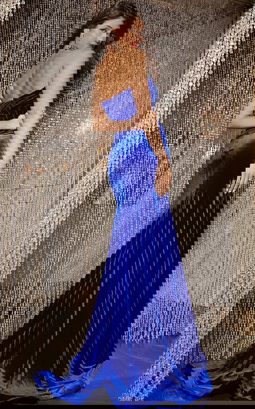 Model in Jovani 43066, Royal Blue velvet gown with a strapless neckline and high slit.