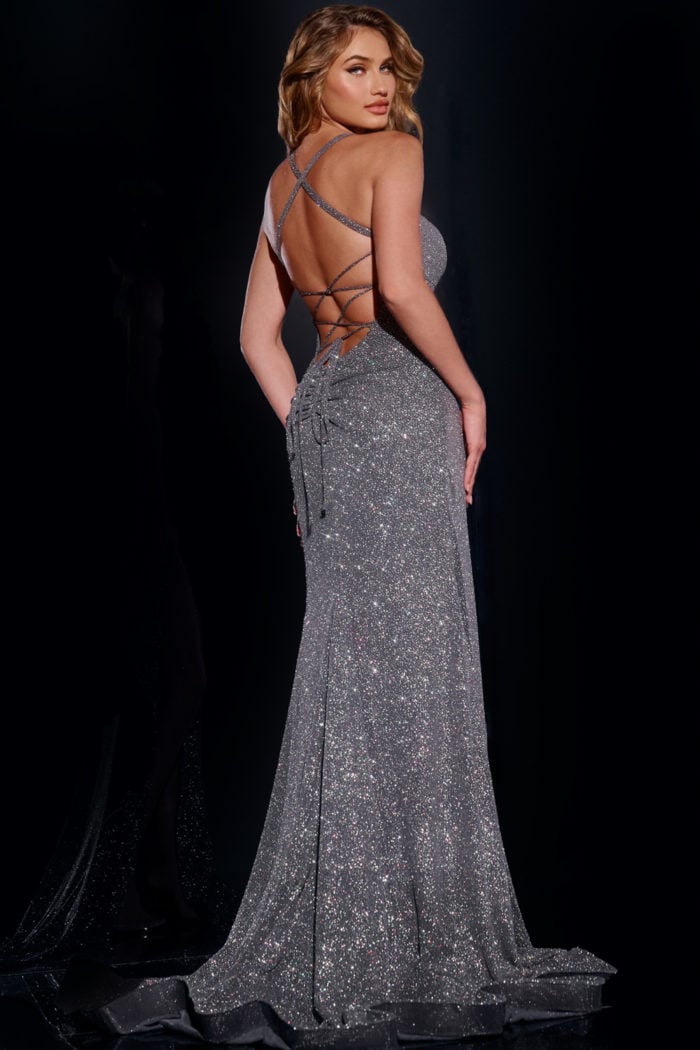 Model showcasing the back of Jovani 43080 gray gown with criss-cross detailing.