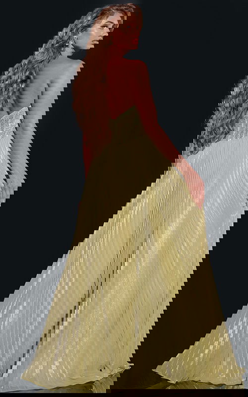 Back view of model wearing Jovani 43115 green gown with elegant pleats.