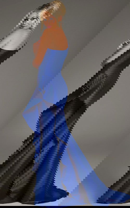 Model showing back of Jovani 43126 dress, cascading ruffle detail in purple.