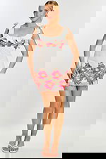 Front view of white eyelet mini dress with floral embroidery and ruffled straps