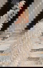 Back view of a strapless gown with floral appliqué and flowing tulle skirt