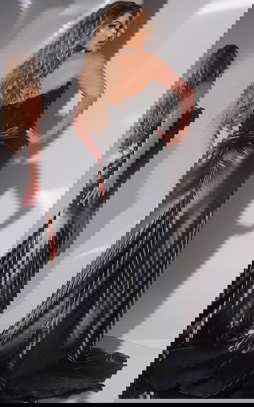 Model wearing Jovani 43267 in black showcasing back with subtle ruching.