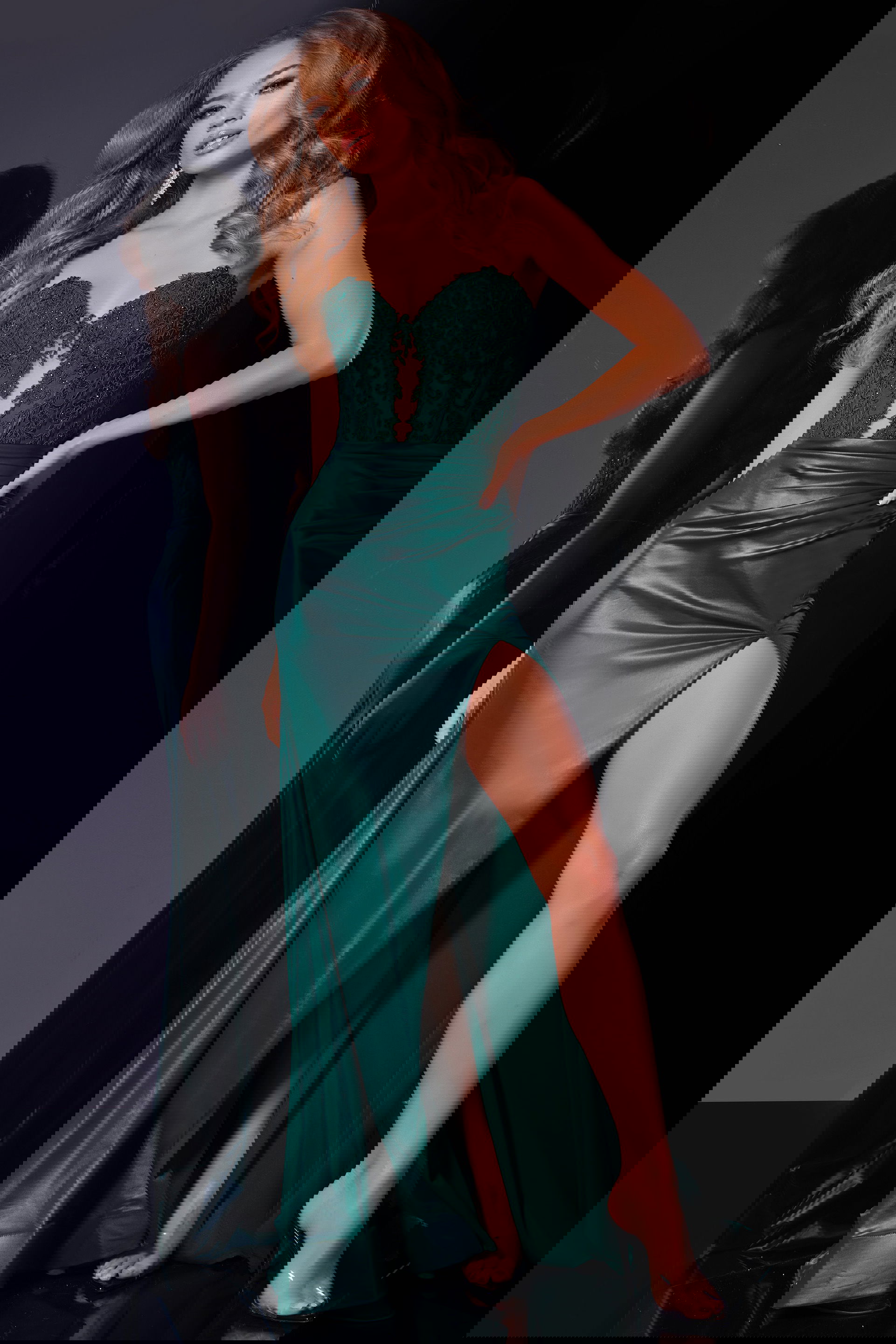 43267-green Model wearing Jovani 43267 in green with illusion neckline and high slit front view.