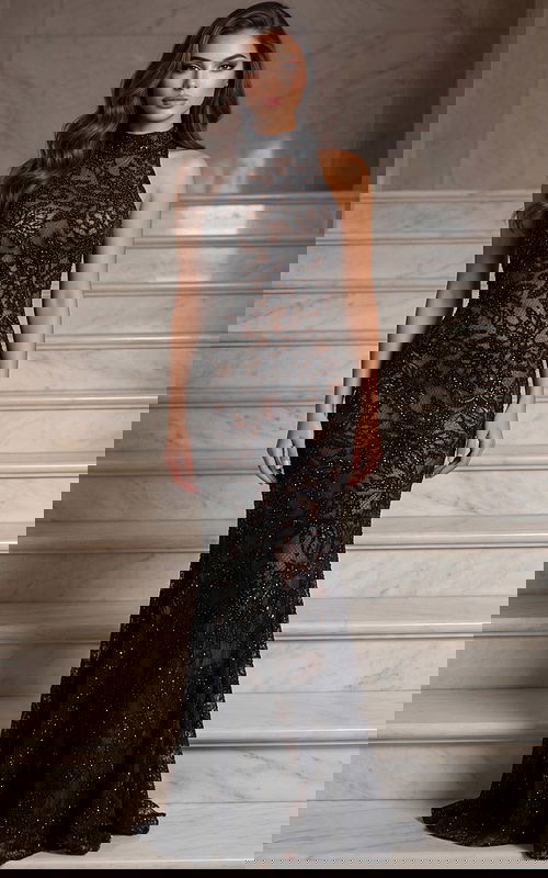 Halter neck lace gown with illusion bodice and fitted silhouette