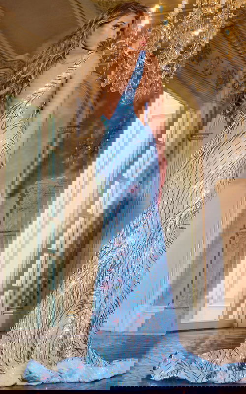 Model wearing Jovani 43407 blue gown with low back, back view