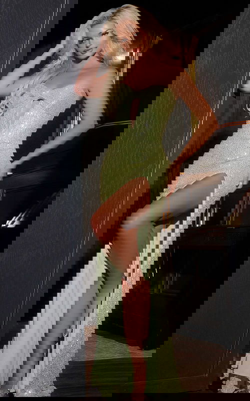 Model wearing Jovani 43441 green gown with sweetheart neckline and high slit