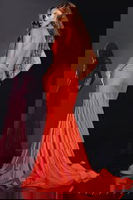 Back view of model wearing Jovani 43573 orange gown with low-cut back.