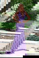 Lavender shimmer gown featuring deep neckline and thigh-high slit