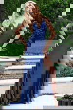 Blue gown with open back and ruched detailing at the waist