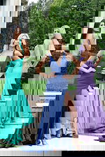 Model wearing shimmer jersey gown with open back and high slit