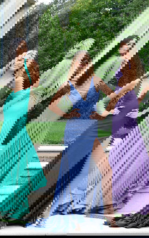 Model wearing shimmer jersey gown with open back and high slit