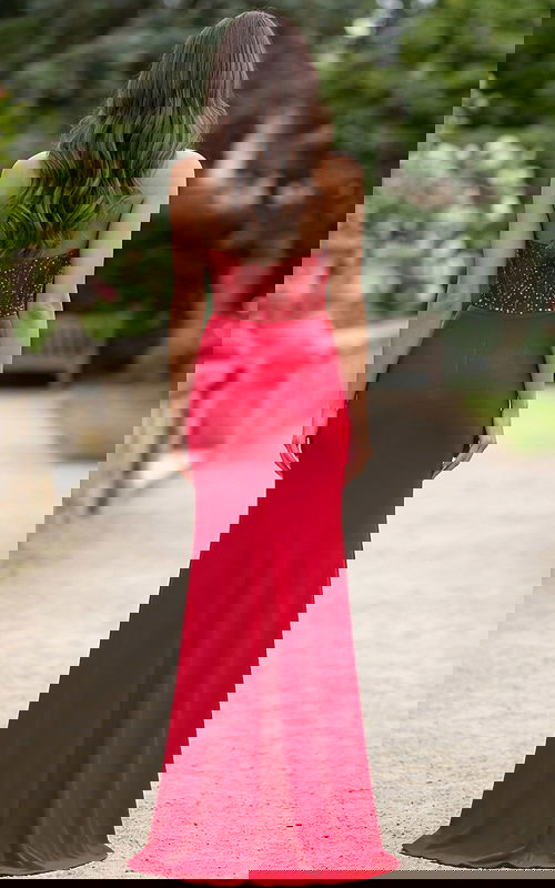 Back view of strapless red gown with beaded bodice and sleek column skirt.