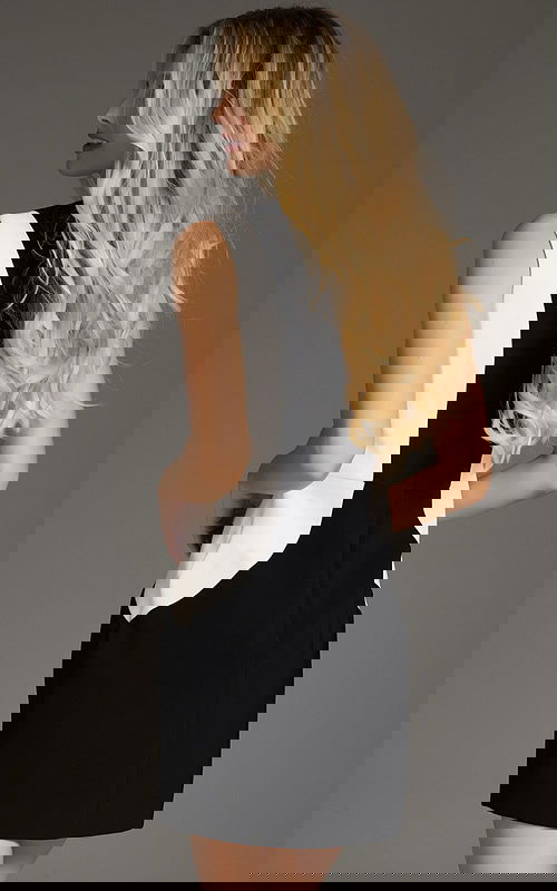 Back view of model wearing Jovani 43593 black and white mini dress.