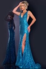 Model wearing Jovani 43725 blue gown with high slit and sequined design.