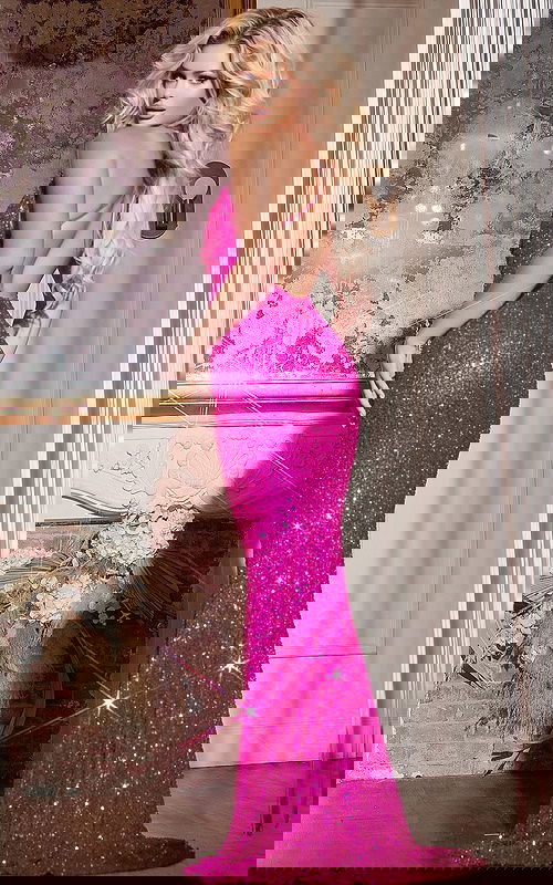 Model showing Jovani 43746 fuchsia gown from back, highlighting the low-cut back design.