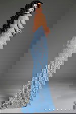 Back view of model in Jovani 43760 blue lace mermaid gown highlighting strapless style.