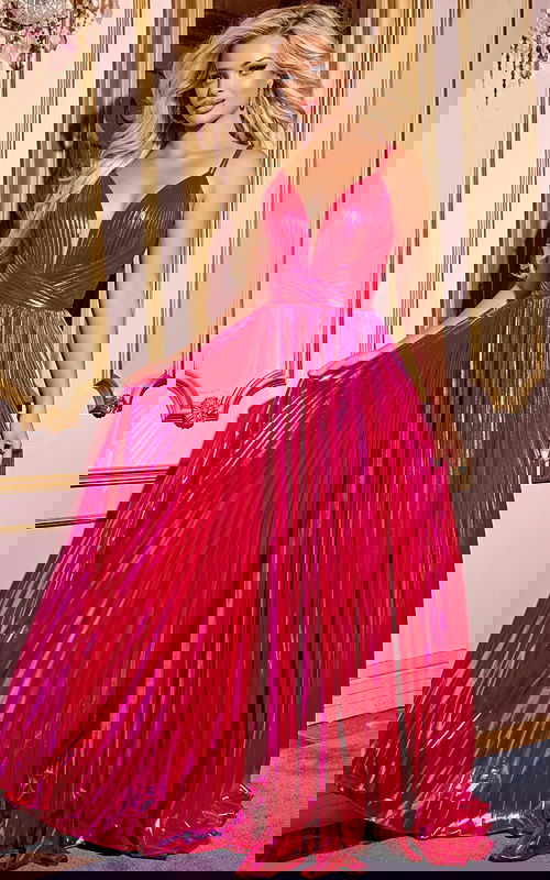 Model wearing Jovani 43795, front view of a fuchsia pleated gown with deep V-neckline.