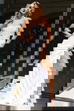 Front view of strapless embellished gown with high slit