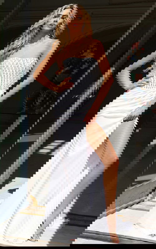 Front view of strapless embellished gown with high slit