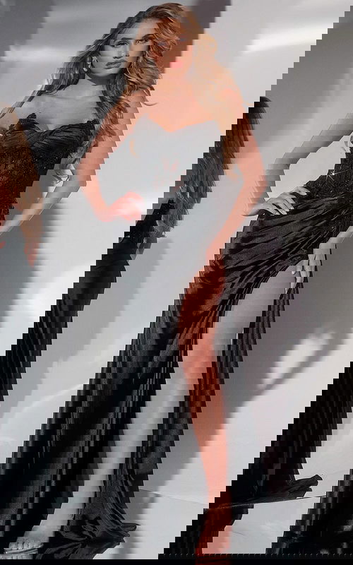 Model wearing Jovani 43848 black evening gown with sweetheart neckline and high slit, front view.