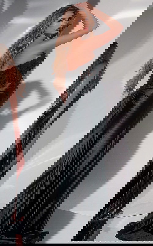 Model wearing Jovani 43848 black evening gown, showcasing the back details.